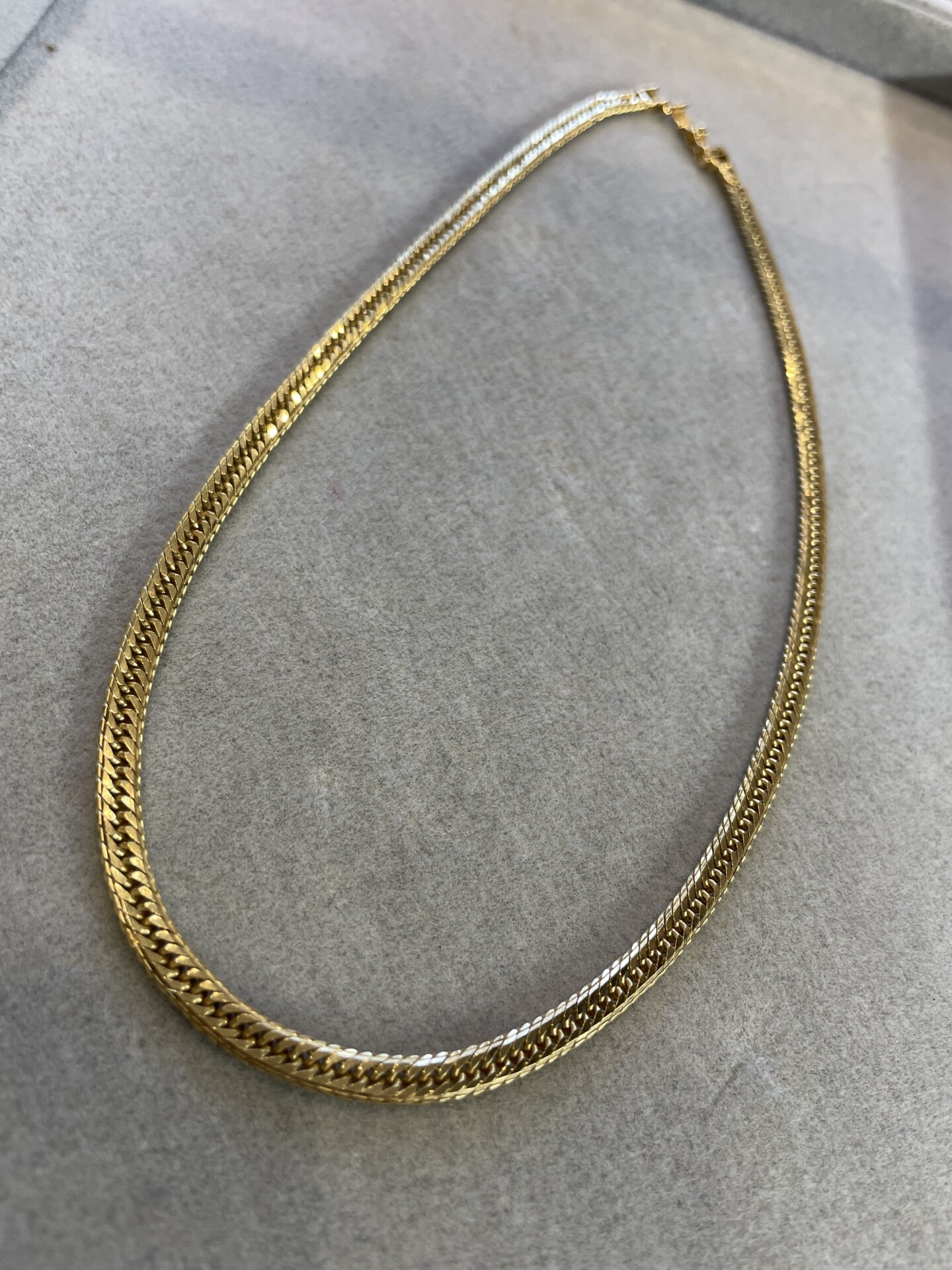 An 18-karat gold mirror cut design (multi-faceted cut design) kihei necklace.